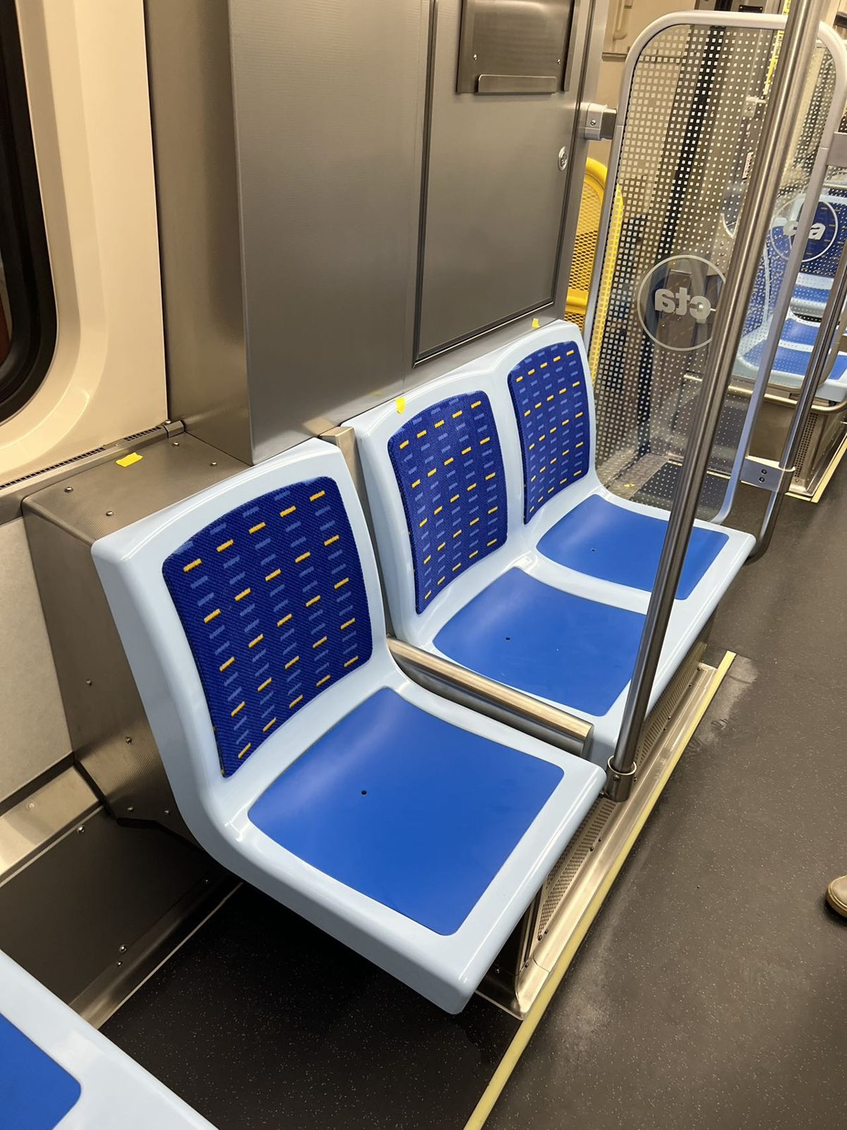 Passenger seats with upholstered backs installed in a CTA 7000 Series car