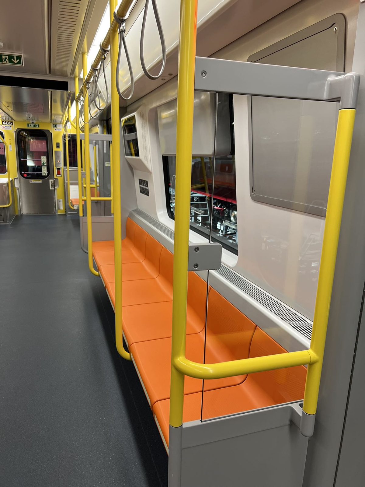 Stainless handrails and stanchions in a transit car