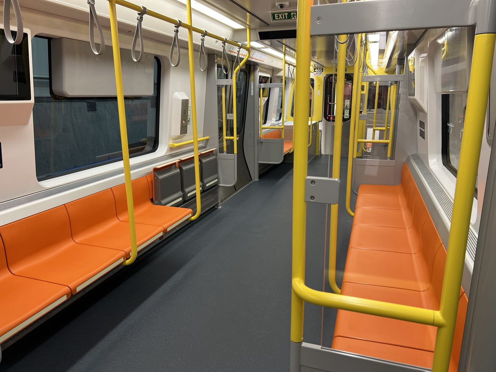 Interior of an MBTA Orange Line car with orange seating