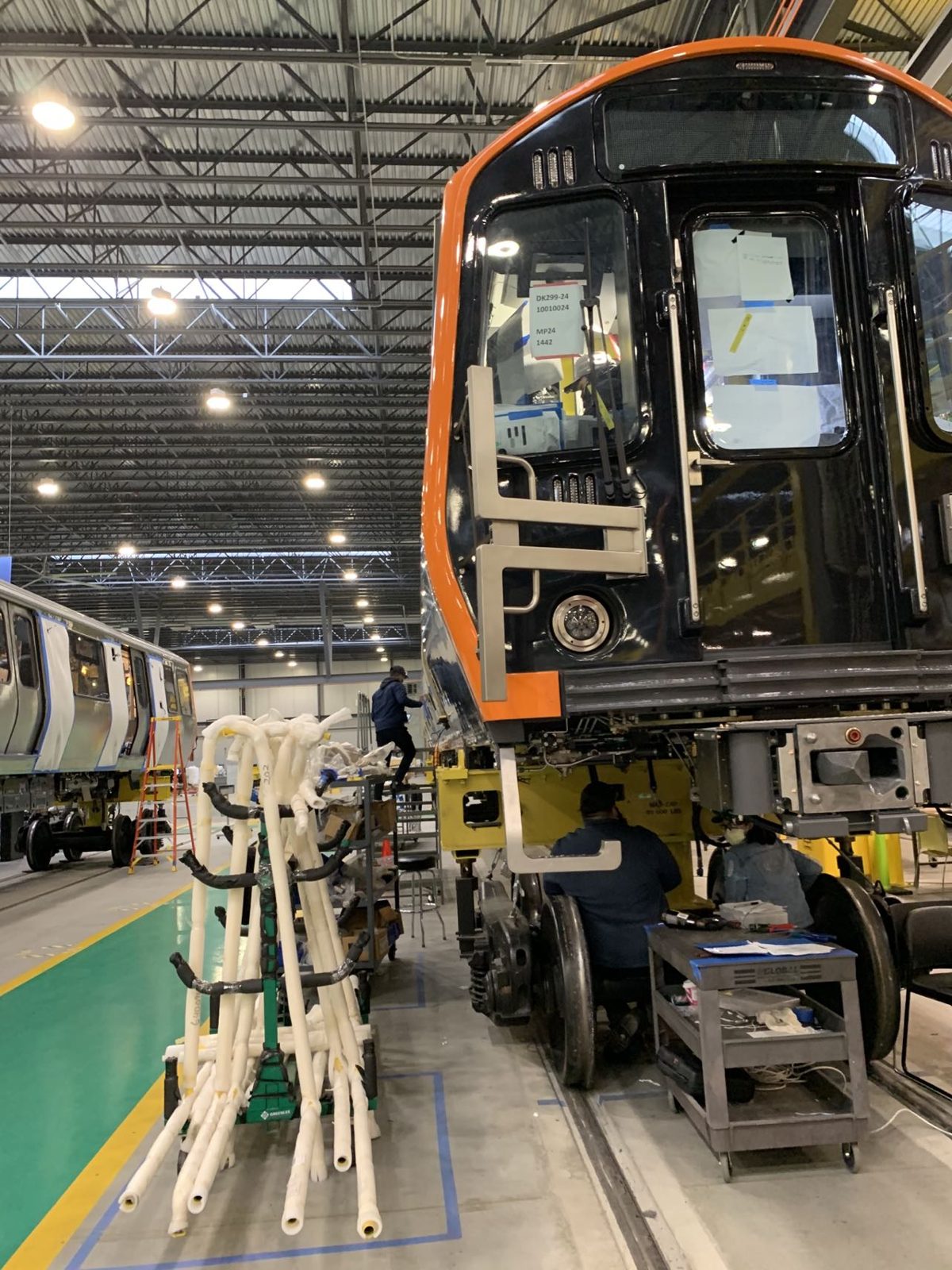Sanlaser technicians supporting installation on a railcar at the assembly plant